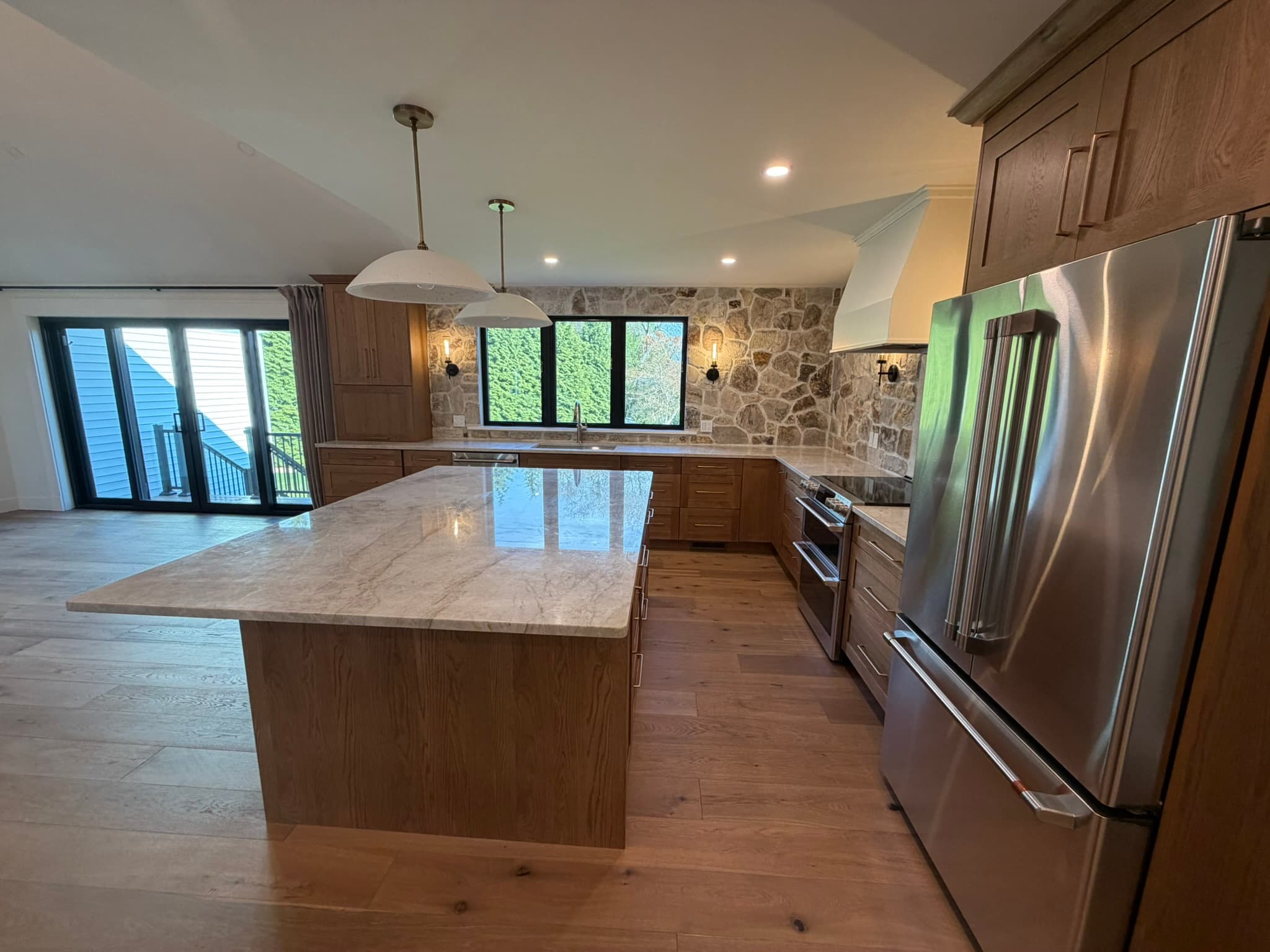 Open kitchen and great room with the marble island and black-framed windows