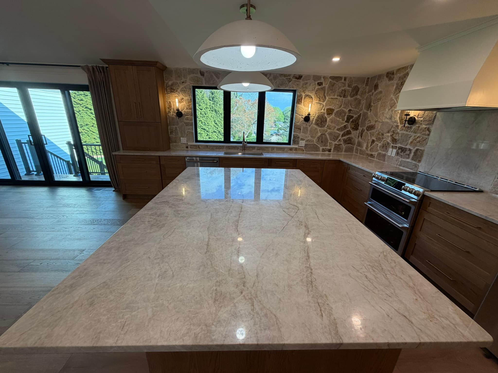 Kitchen island with waterfall marble and open sightlines to the great room