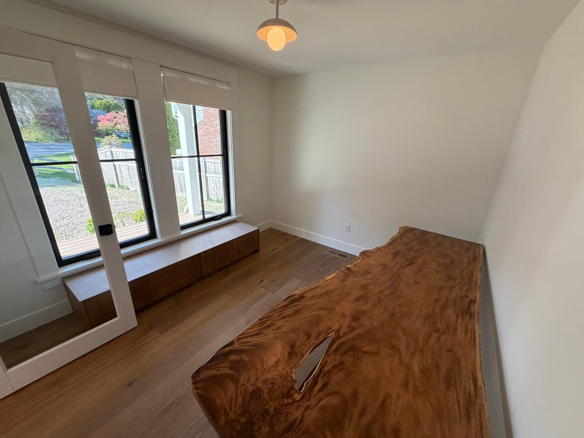 Custom live-edge bench beneath a window