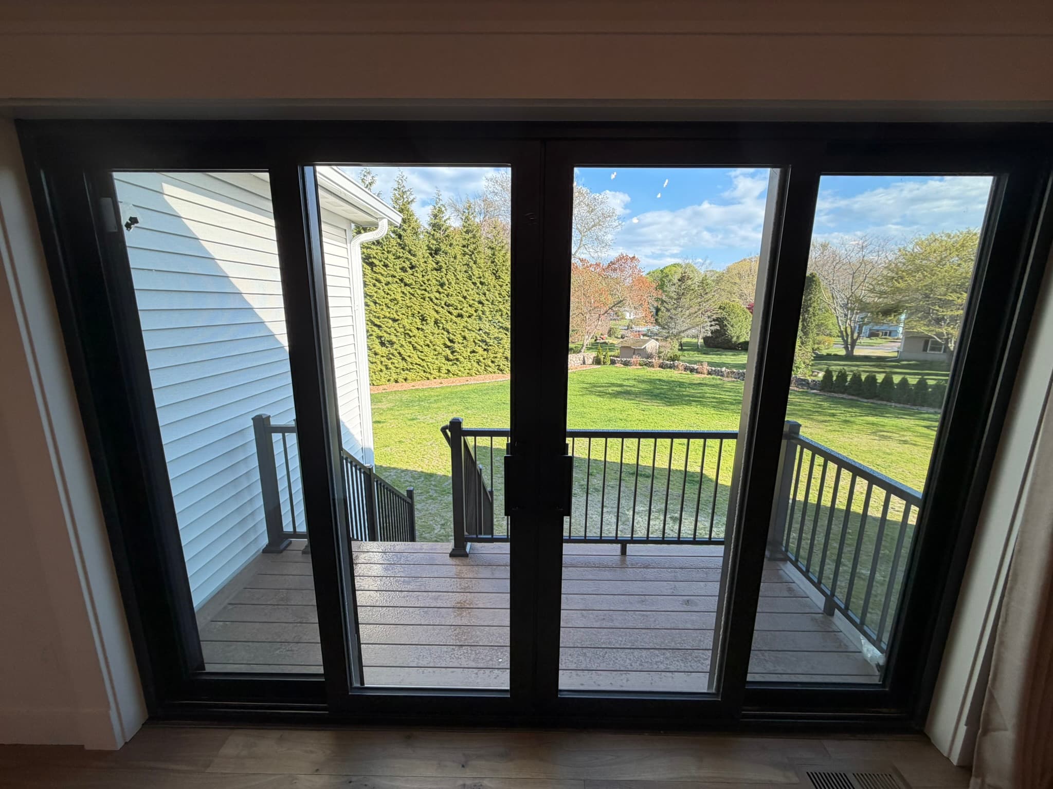 Sliding glass doors opening to the deck and rear yard